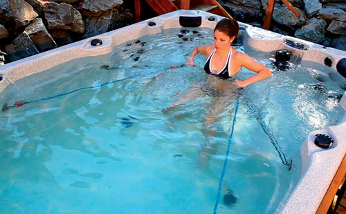 A woman rowing in the swim spa